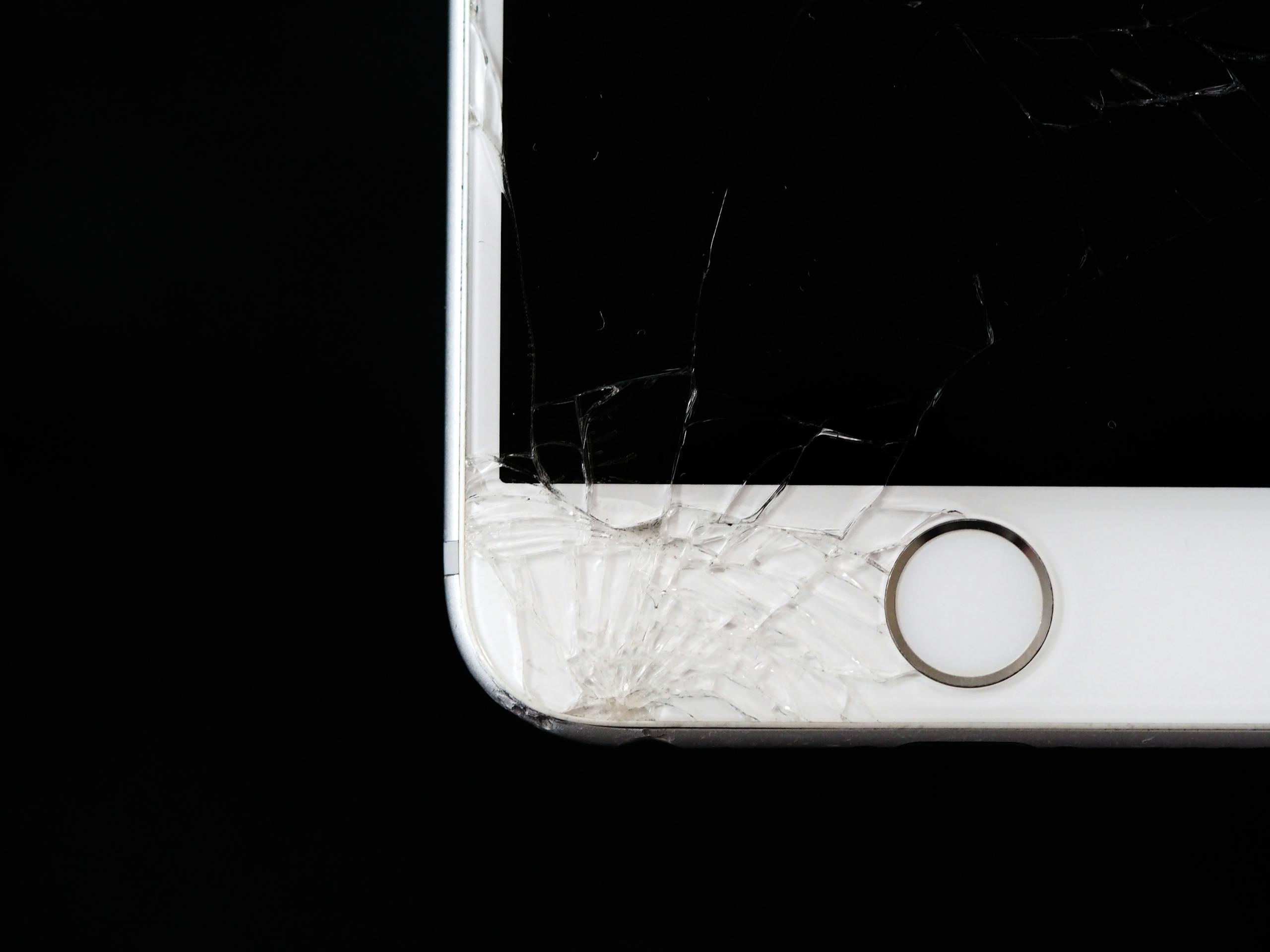 Detailed image of a cracked smartphone screen highlighting damage to the device.